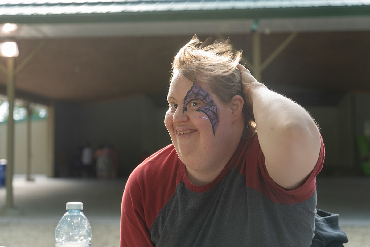 a smiling girl wearing facepaint