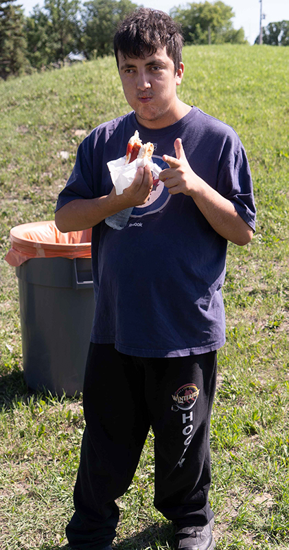 a man eats a hotdog